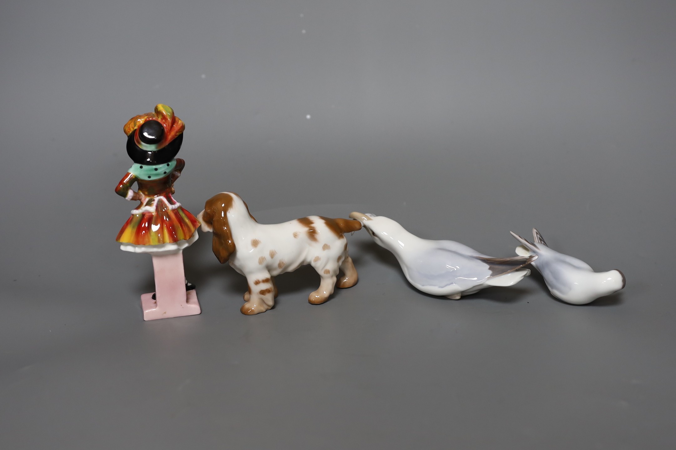 A Royal Doulton figure,”Pearly Girl”, HN 2036, two Bing and Grondahl birds and a dog, figure 14 cms high